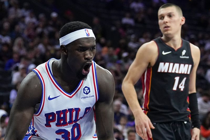 PHILADELPHIA, PENNSYLVANIA - MARCH 29: Adem Bona #30 of the Philadelphia 76ers reacts in front of Tyler Herro #14 of the Miami Heat in the first half at the Wells Fargo Center on March 29, 2025 in Philadelphia, Pennsylvania. NOTE TO USER: User expressly acknowledges and agrees that, by downloading and/or using this photograph, user is consenting to the terms and conditions of the Getty Images License Agreement. (Photo by Mitchell Leff/Getty Images)