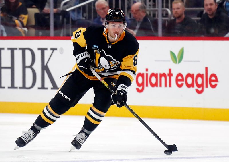 Oct 16, 2024; Pittsburgh, Pennsylvania, USA; Pittsburgh Penguins left wing Michael Bunting (8) skates with the puck against the Buffalo Sabres during the third period at PPG Paints Arena. The Pens won 6-5 in overtime. Mandatory Credit: Charles LeClaire-Imagn Images