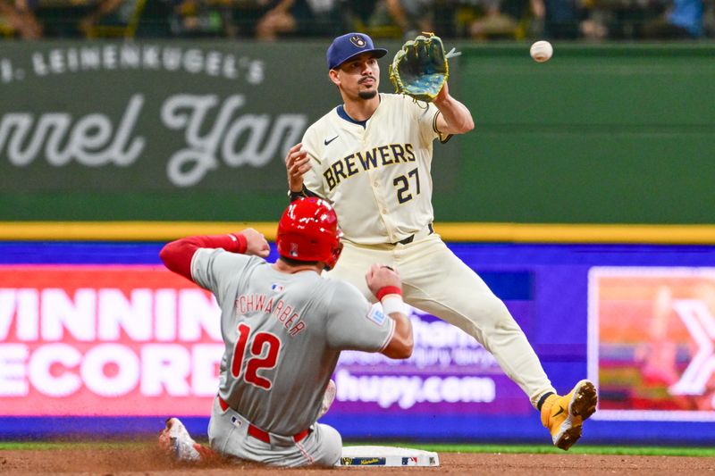 Sep 18, 2024; Milwaukee, Wisconsin, USA; Milwaukee Brewers shortstop Willy Adames (27) forces out Philadelphia Phillies designated hitter Kyle Schwarber (12) in the eighth inning at American Family Field. Mandatory Credit: Benny Sieu-Imagn Images
