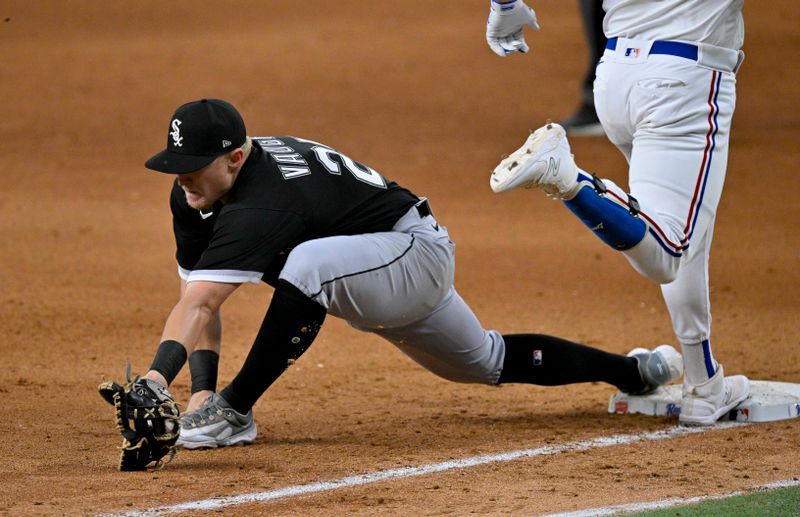 Aug 3, 2023; Arlington, Texas, USA; Chicago White Sox first baseman Andrew Vaughn (25) puts out Texas Rangers first baseman Nathaniel Lowe (30) during the seventh inning at Globe Life Field. Mandatory Credit: Jerome Miron-USA TODAY Sports