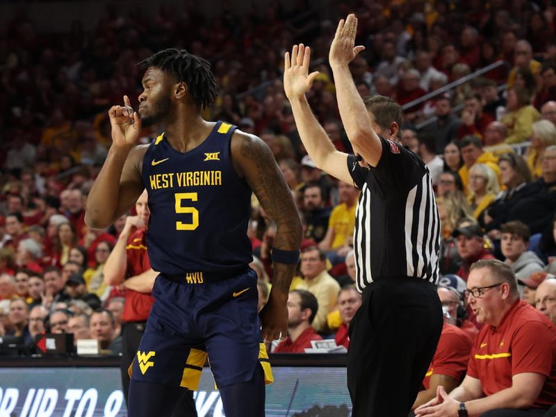 Feb 27, 2023; Ames, Iowa, USA; West Virginia Mountaineers guard Joe Toussaint (5) quiets the Iowa State Cyclones crowd during the first half at James H. Hilton Coliseum. Mandatory Credit: Reese Strickland-USA TODAY Sports