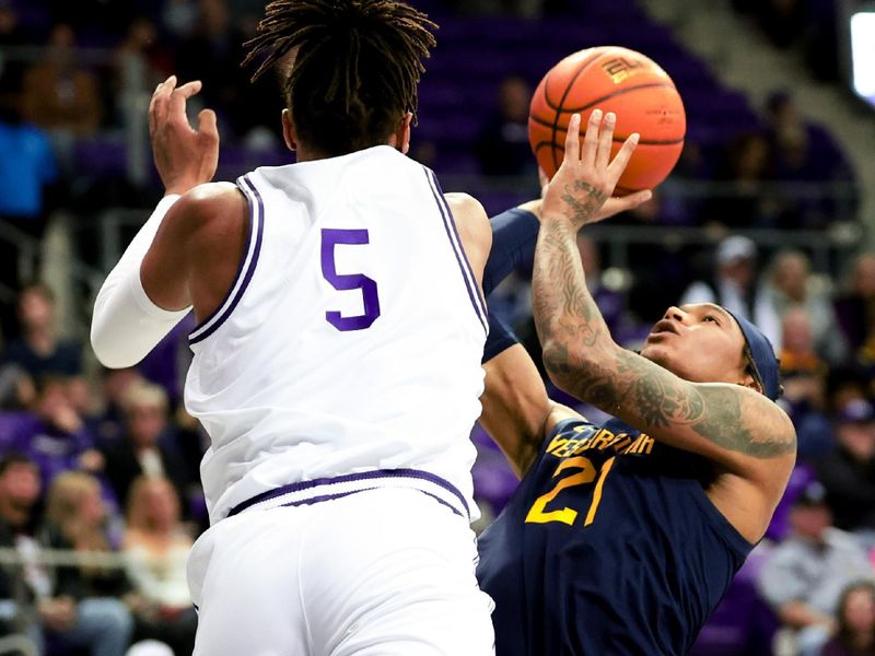 Feb 12, 2024; Fort Worth, Texas, USA;  West Virginia Mountaineers guard RaeQuan Battle (21) shoots as TCU Horned Frogs forward Chuck O'Bannon Jr. (5) defends during the second half at Ed and Rae Schollmaier Arena. Mandatory Credit: Kevin Jairaj-USA TODAY Sports