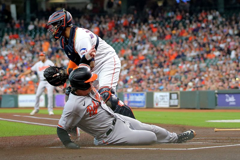 Sep 20, 2023; Houston, Texas, USA; Baltimore Orioles catcher Adley Rutschman (35) slides across home plate to score a run against the Houston Astros during the first inning at Minute Maid Park. Mandatory Credit: Erik Williams-USA TODAY Sports