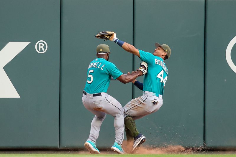 May 20, 2023; Atlanta, Georgia, USA; Seattle Mariners center fielder Julio Rodriguez (44) collides with left fielder Taylor Trammell (5) after a catch against the Atlanta Braves in the second inning at Truist Park. Mandatory Credit: Brett Davis-USA TODAY Sports