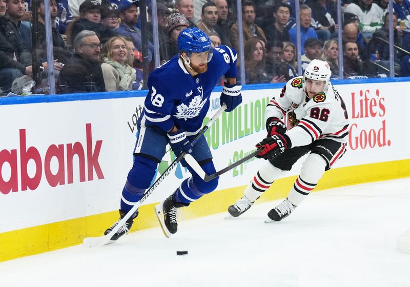 Dec 16, 2025; Toronto, Ontario, CAN; Toronto Maple Leafs right wing William Nylander (88) battles for the puck behind the net with Chicago Blackhawks center Teuvo Teravainen (86) during the first period at Scotiabank Arena. Mandatory Credit: Nick Turchiaro-Imagn Images