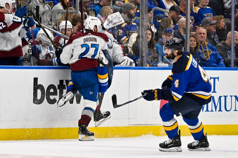 Dec 29, 2023; St. Louis, Missouri, USA;  Colorado Avalanche left wing Jonathan Drouin (27) checks St. Louis Blues center Jordan Kyrou (25) during the third period at Enterprise Center. Mandatory Credit: Jeff Curry-USA TODAY Sports