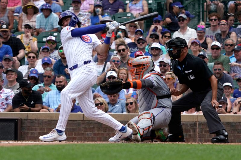 Jun 22, 2024; Chicago, Illinois, USA; Chicago Cubs shortstop Dansby Swanson (7) hits an RBI double against the New York Mets during the first inning at Wrigley Field. Mandatory Credit: David Banks-USA TODAY Sports