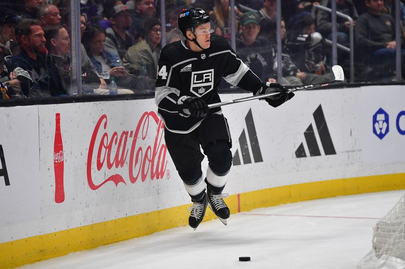 Apr 18, 2024; Los Angeles, California, USA; Los Angeles Kings defenseman Mikey Anderson (44) controls the puck against the Chicago Blackhawks during the first period at Crypto.com Arena. Mandatory Credit: Gary A. Vasquez-USA TODAY Sports