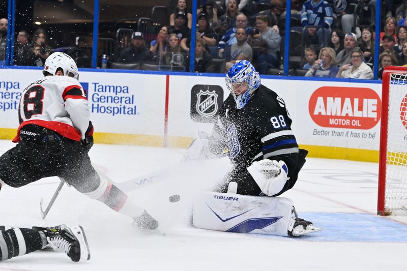 Mar 28, 2026; Tampa, Florida, USA; Tampa Bay Lightning goalie Andrei Vasilevskiy (88) blocks a shot from Ottawa Senators center Tim Stutzle (18) during the second period at Benchmark International Arena. Mandatory Credit: Pablo Robles-Imagn Images