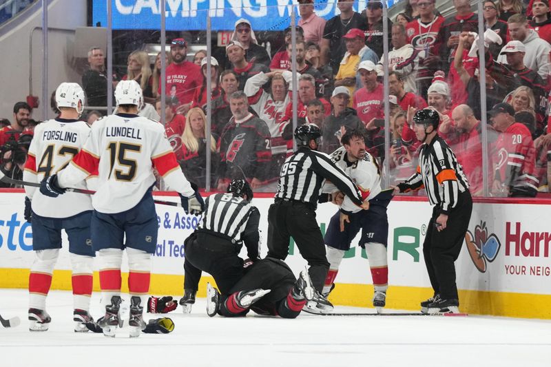 May 20, 2025; Raleigh, North Carolina, USA; Florida Panthers forward Brad Marchand (63) fights Carolina Hurricanes defenseman Shayne Gostibehere (4) during the third period in game one of the Eastern Conference Final of the 2025 Stanley Cup Playoffs at Lenovo Center. Mandatory Credit: James Guillory-Imagn Images