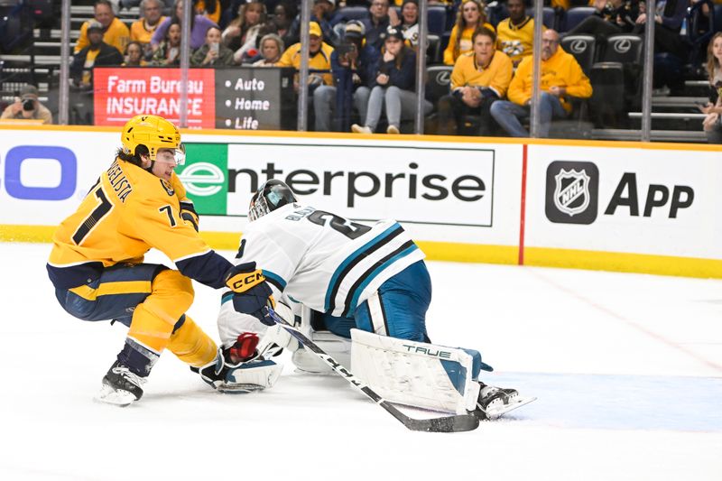 Oct 21, 2023; Nashville, Tennessee, USA; Nashville Predators right wing Luke Evangelista (77) scores past San Jose Sharks goaltender Mackenzie Blackwood (29) during the third period at Bridgestone Arena. Mandatory Credit: Steve Roberts-USA TODAY Sports