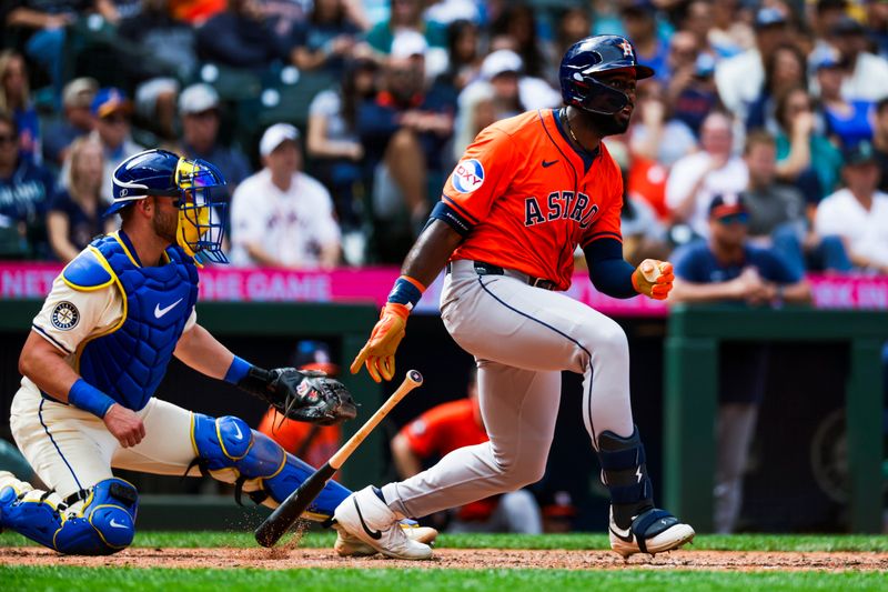 Jul 20, 2025; Seattle, Washington, USA; Houston Astros center fielder Taylor Trammell (26) hits a single against the Seattle Mariners during the eighth inning at T-Mobile Park. Mandatory Credit: Joe Nicholson-Imagn Images