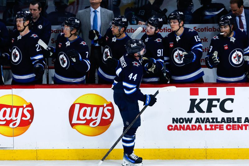 Feb 24, 2025; Winnipeg, Manitoba, CAN;  Winnipeg Jets defenseman Josh Morrissey (44) is congratulated by his team mates on his goal against the San Jose Sharks during the third period at Canada Life Centre. Mandatory Credit: Terrence Lee-Imagn Images