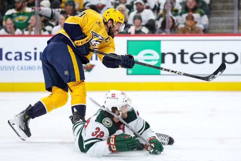 Nov 30, 2024; Saint Paul, Minnesota, USA; Nashville Predators defenseman Roman Josi (59) shoots as Minnesota Wild right wing Ryan Hartman (38) defends during the third period at Xcel Energy Center. Mandatory Credit: Matt Krohn-Imagn Images