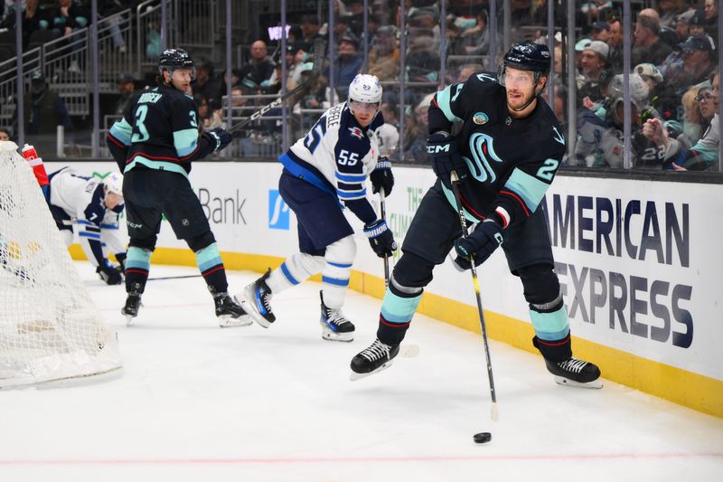 Mar 8, 2024; Seattle, Washington, USA; Seattle Kraken defenseman Jamie Oleksiak (24) passes the puck during the third period against the Winnipeg Jets at Climate Pledge Arena. Mandatory Credit: Steven Bisig-USA TODAY Sports