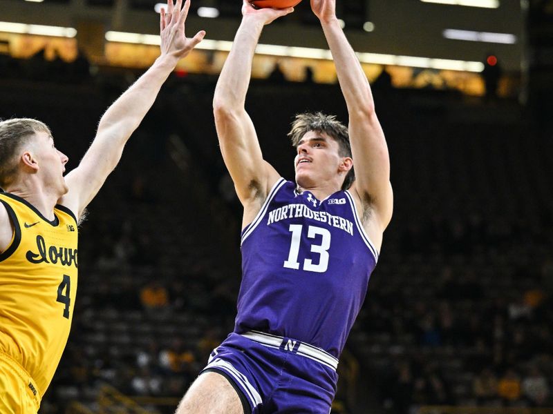 Dec 3, 2024; Iowa City, Iowa, USA; Northwestern Wildcats guard Brooks Barnhizer (13) shoots the ball as Iowa Hawkeyes guard Josh Dix (4) defends during the first half at Carver-Hawkeye Arena. Mandatory Credit: Jeffrey Becker-Imagn Images