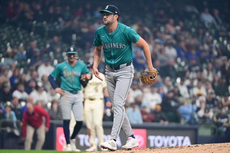 Apr 7, 2024; Milwaukee, Wisconsin, USA; Seattle Mariners pitcher Collin Snider (52) reacts after being hit by a line drive in the fourth inning against the Milwaukee Brewers at American Family Field. Mandatory Credit: Benny Sieu-USA TODAY Sports