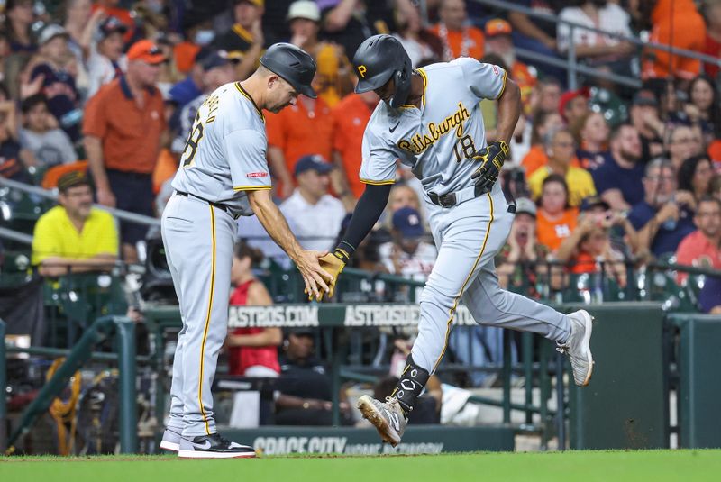 Jul 30, 2024; Houston, Texas, USA; Pittsburgh Pirates center fielder Michael A. Taylor (18) celebrates with third base coach and field coordinator Mike Rabelo (58) after hitting a home run during the sixth inning against the Houston Astros at Minute Maid Park. Mandatory Credit: Troy Taormina-USA TODAY Sports