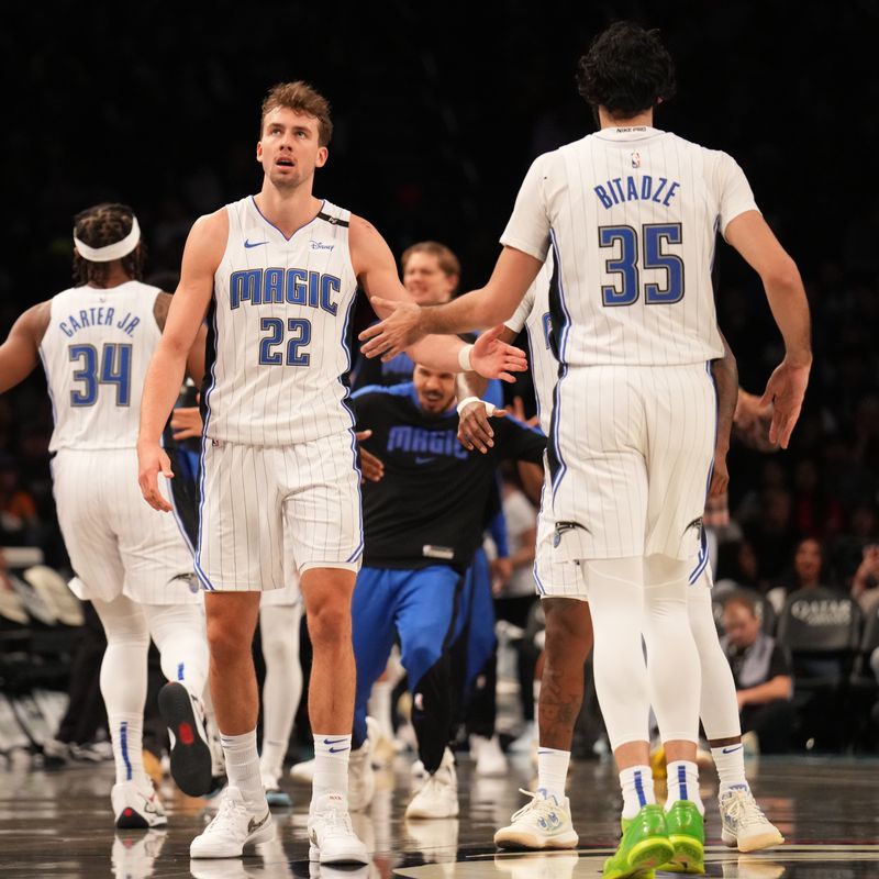 BROOKLYN, NY - DECEMBER 1: Franz Wagner #22 and Goga Bitadze #35 of the Orlando Magic high five during the game against the Brooklyn Nets on December 1, 2024 at Barclays Center in Brooklyn, New York. NOTE TO USER: User expressly acknowledges and agrees that, by downloading and or using this Photograph, user is consenting to the terms and conditions of the Getty Images License Agreement. Mandatory Copyright Notice: Copyright 2024 NBAE (Photo by Jesse D. Garrabrant/NBAE via Getty Images)