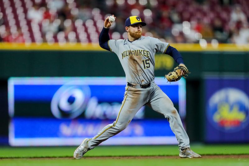 Apr 9, 2024; Cincinnati, Ohio, USA; Milwaukee Brewers third baseman Oliver Dunn (15) throws to first to get Cincinnati Reds catcher Tyler Stephenson (not pictured) out in the fifth inning at Great American Ball Park. Mandatory Credit: Katie Stratman-USA TODAY Sports