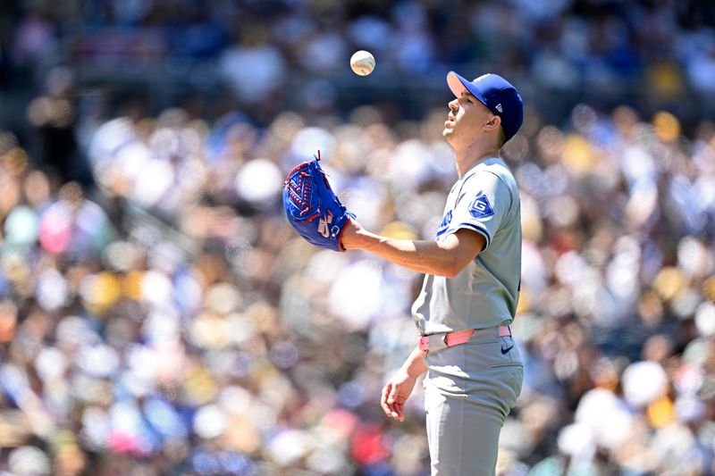 May 12, 2024; San Diego, California, USA; Los Angeles Dodgers starting pitcher Walker Buehler (21) tosses a ball in the air during the fourth inning against the San Diego Padres at Petco Park. Mandatory Credit: Orlando Ramirez-USA TODAY Sports