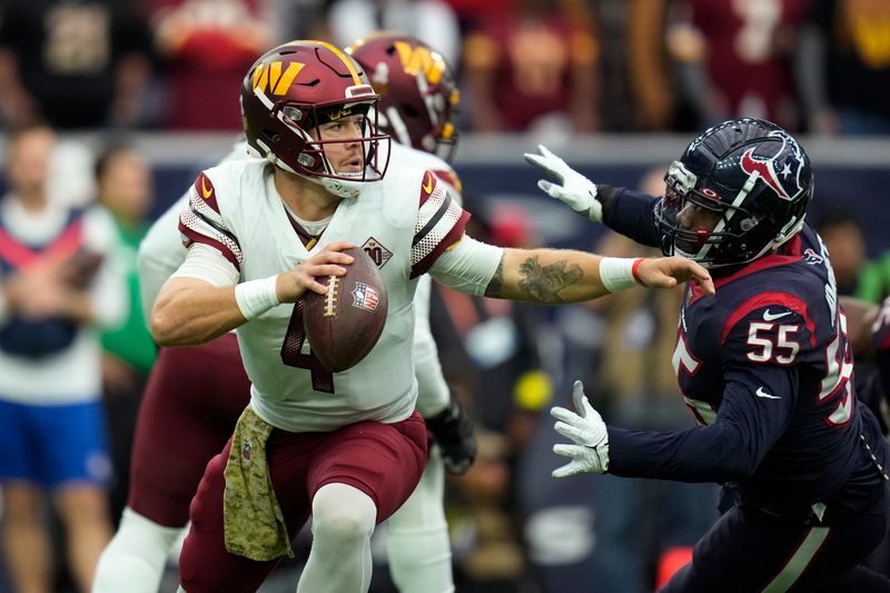 Washington Commanders quarterback Taylor Heinicke (4) is pressured by Houston Texans defensive end Jerry Hughes (55) during the first half of an NFL football game Sunday, Nov. 20, 2022, in Houston. (AP Photo/Eric Christian Smith)