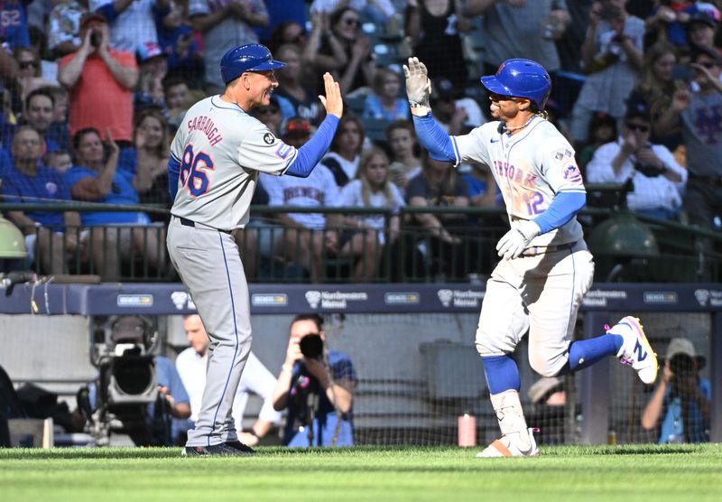 Sep 29, 2024; Milwaukee, Wisconsin, USA;New York Mets shortstop Francisco Lindor (12) is congratulated by New York Mets second base Eddy Alvarez (26) while rounding the bases after hitting a home run against the Milwaukee Brewers in the sixth inning at American Family Field. Mandatory Credit: Michael McLoone-Imagn Images