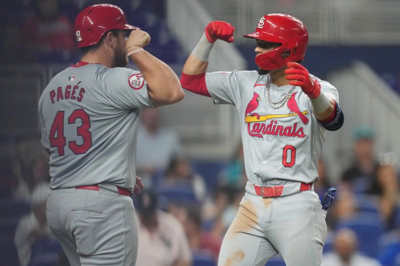 Jun 17, 2024; Miami, Florida, USA;  St. Louis Cardinals shortstop Masyn Winn (0) celebrates a two-run home run against the Miami Marlins in the 12th inning with catcher Pedro Pagés (43) at loanDepot Park. Mandatory Credit: Jim Rassol-USA TODAY Sports