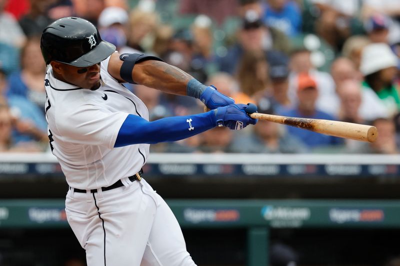 Aug 23, 2023; Detroit, Michigan, USA;  Detroit Tigers second baseman Andy Ibanez (77) hits a single in the sixth inning against the Chicago Cubs at Comerica Park. Mandatory Credit: Rick Osentoski-USA TODAY Sports