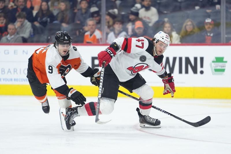 Nov 22, 2025; Philadelphia, Pennsylvania, USA; New Jersey Devils center Paul Cotter (47) loses control of the puck against Philadelphia Flyers defenseman Jamie Drysdale (9) in the second period at Xfinity Mobile Arena. Mandatory Credit: Kyle Ross-Imagn Images
