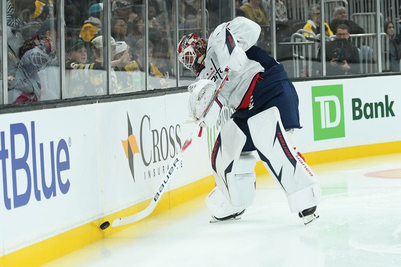 Sep 21, 2025; Boston, Massachusetts, USA; Washington Capitals goaltender Logan Thompson (48) shoots the puck along the boards during the first period against the Boston Bruins at TD Garden. Mandatory Credit: Bob DeChiara-Imagn Images
