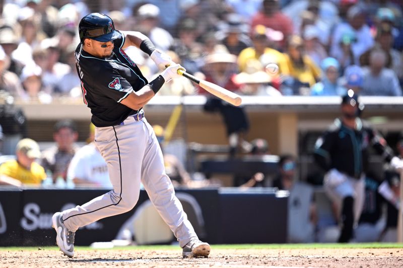 Jul 7, 2024; San Diego, California, USA; Arizona Diamondbacks catcher Gabriel Moreno (14) hits an RBI single against the San Diego Padres during the eighth inning at Petco Park. Mandatory Credit: Orlando Ramirez-USA TODAY Sports