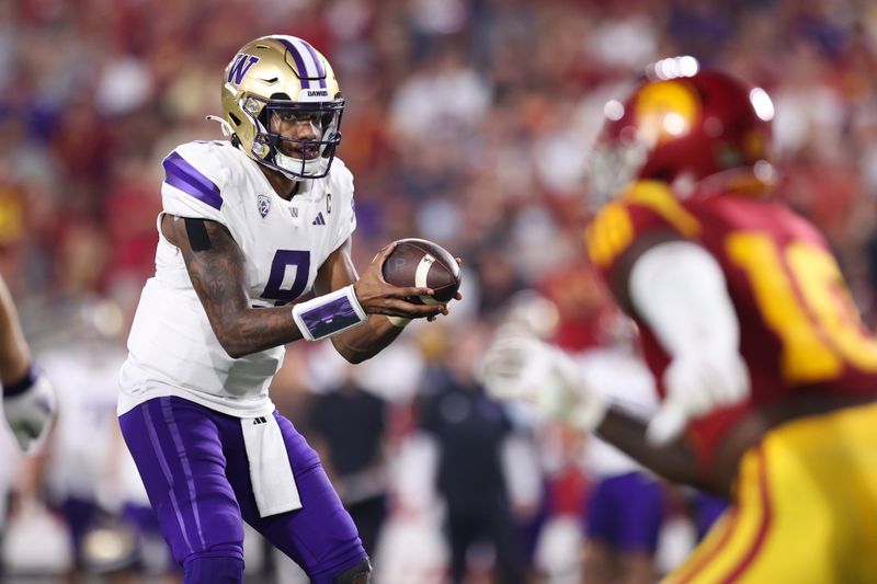 Nov 4, 2023; Los Angeles, California, USA; Washington Huskies quarterback Michael Penix Jr. (9) receives a snap during the second quarter against the USC Trojans at United Airlines Field at Los Angeles Memorial Coliseum. Mandatory Credit: Jessica Alcheh-USA TODAY Sports