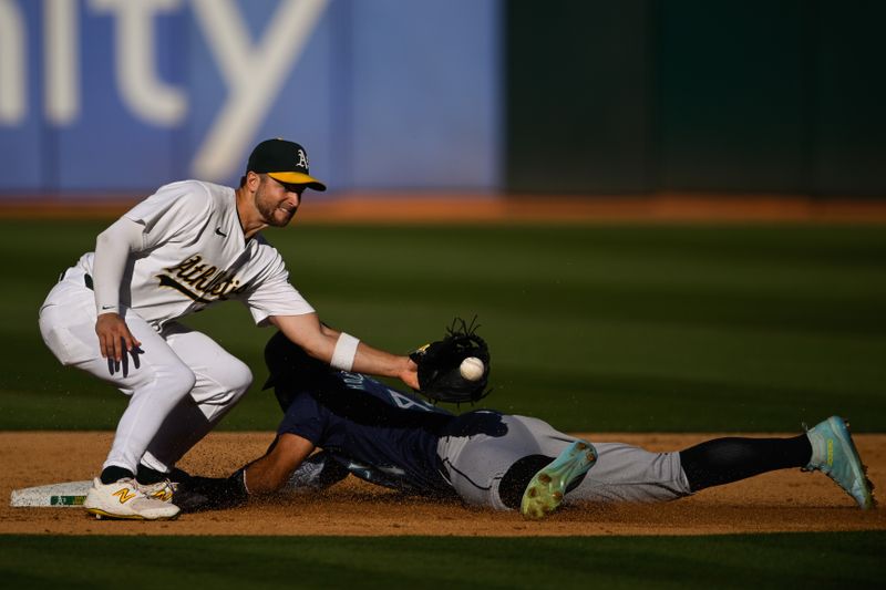 Sep 2, 2024; Oakland, California, USA; Seattle Mariners outfielder Julio Rodríguez (44) steals second base against Oakland Athletics shortstop Max Schuemann (12) in the sixth inning at Oakland-Alameda County Coliseum. Mandatory Credit: Eakin Howard-USA TODAY Sports