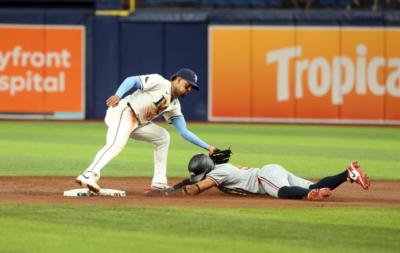 Sep 3, 2024; St. Petersburg, Florida, USA;  Minnesota Twins outfielder Willi Castro (50) steals second base as Tampa Bay Rays infielder Christopher Morel (24) attempts to tag him out during the second inning at Tropicana Field. Mandatory Credit: Kim Klement Neitzel-Imagn Images