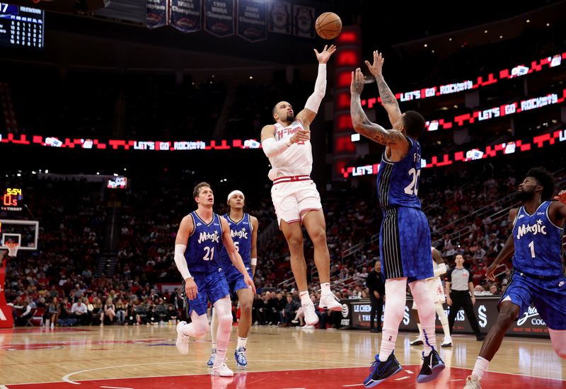 HOUSTON, TEXAS - APRIL 09: Dillon Brooks #9 of the Houston Rockets shoots the ball between Moritz Wagner #21 of the Orlando Magic and Markelle Fultz #20 in the second half at Toyota Center on April 09, 2024 in Houston, Texas.  NOTE TO USER: User expressly acknowledges and agrees that, by downloading and or using this photograph, User is consenting to the terms and conditions of the Getty Images License Agreement. (Photo by Tim Warner/Getty Images)