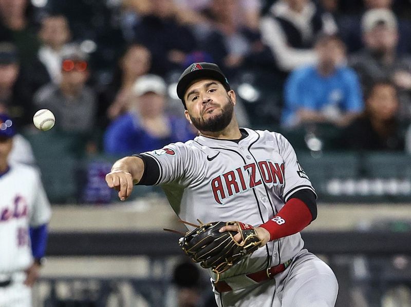 May 30, 2024; New York City, New York, USA;  Arizona Diamondbacks third baseman Eugenio Suárez (28) makes an off balanced throw to first base for an out in the fourth inning against the New York Mets at Citi Field. Mandatory Credit: Wendell Cruz-USA TODAY Sports