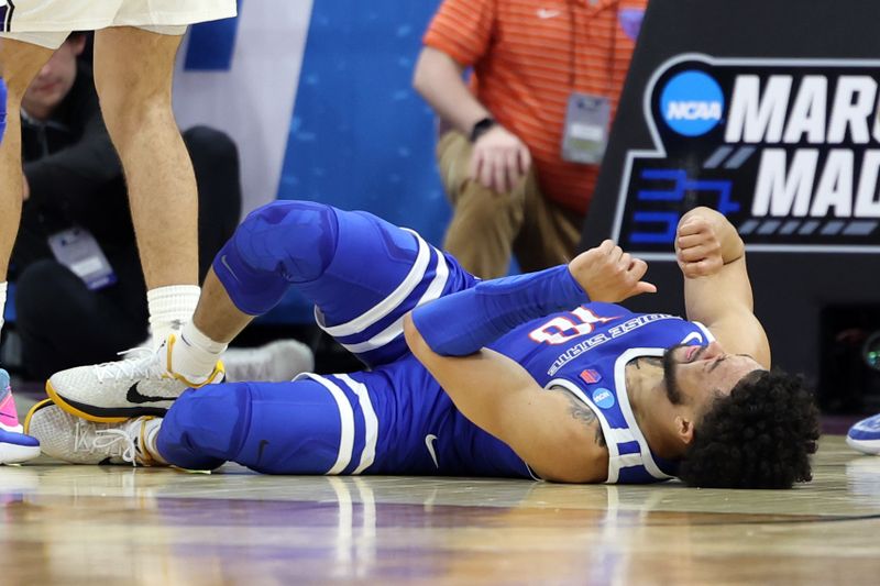 Mar 16, 2023; Sacramento, CA, USA; Boise State Broncos guard Marcus Shaver Jr. (10) reacts on the floor to an apparent injury in the first half against the Northwestern Wildcats at Golden 1 Center. Mandatory Credit: Kelley L Cox-USA TODAY Sports