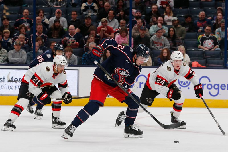 Mar 14, 2024; Columbus, Ohio, USA; Columbus Blue Jackets center Alexander Texier (42) grabs a loose puck as Ottawa Senators defenseman Jacob Bernard-Docker (24) trails the play during the third period at Nationwide Arena. Mandatory Credit: Russell LaBounty-USA TODAY Sports