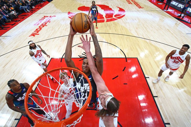 TORONTO, CANADA - MARCH 25: Noah Clowney #21 of the Brooklyn Nets dunks the ball during the game against the Toronto Raptors on March 25, 2024 at the Scotiabank Arena in Toronto, Ontario, Canada.  NOTE TO USER: User expressly acknowledges and agrees that, by downloading and or using this Photograph, user is consenting to the terms and conditions of the Getty Images License Agreement.  Mandatory Copyright Notice: Copyright 2024 NBAE (Photo by Vaughn Ridley/NBAE via Getty Images)