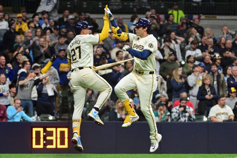 Apr 5, 2024; Milwaukee, Wisconsin, USA; Milwaukee Brewers left fielder Christian Yelich (22) celebrates with shortstop Willy Adames (27) after hitting a solo home run in the sixth inning against the Seattle Mariners  at American Family Field. Mandatory Credit: Benny Sieu-USA TODAY Sports