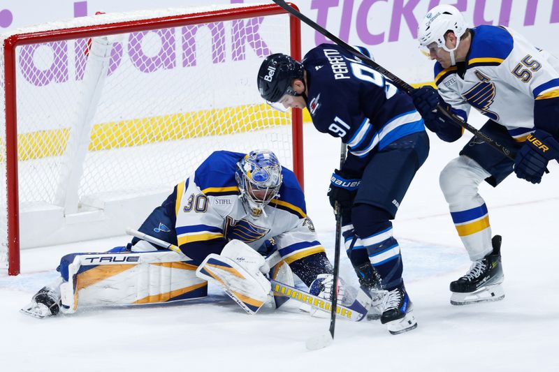 Dec 3, 2024; Winnipeg, Manitoba, CAN;  St. Louis Blues goalie Joel Hofer (30) looks for the puck in the skates of Winnipeg Jets forward Cole Perfetti (91) during the third period at Canada Life Centre. Mandatory Credit: Terrence Lee-Imagn Images