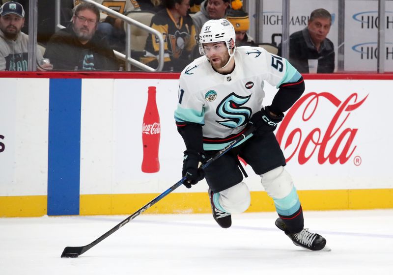 Jan 14, 2025; Pittsburgh, Pennsylvania, USA;  Seattle Kraken center Shane Wright (51) skates with the puck against the Pittsburgh Penguins during the second period at PPG Paints Arena. Mandatory Credit: Charles LeClaire-Imagn Images