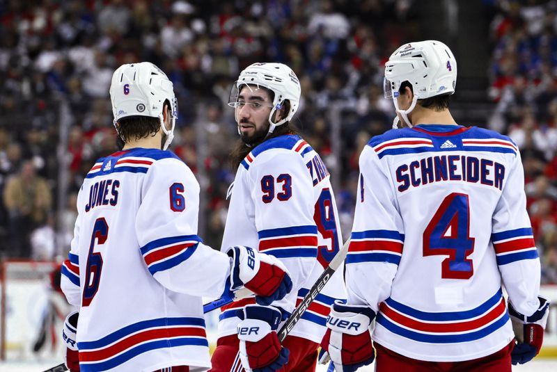 Nov 18, 2023; Newark, New Jersey, USA; New York Rangers defenseman Zac Jones (6), New York Rangers center Mika Zibanejad (93) and New York Rangers defenseman Braden Schneider (4) talk during a break in the action during the second period against the New Jersey Devils at Prudential Center. Mandatory Credit: John Jones-USA TODAY Sports