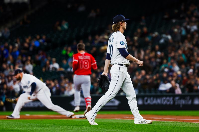 Apr 29, 2025; Seattle, Washington, USA; Seattle Mariners starting pitcher Bryce Miller (50) returns to the dugout following a double play against the Los Angeles Angels during the third inning at T-Mobile Park. Mandatory Credit: Joe Nicholson-Imagn Images