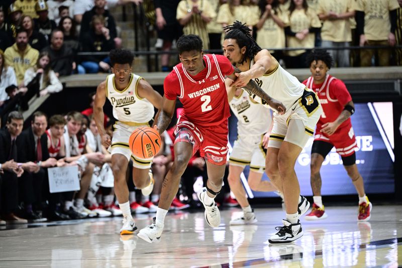 Mar 10, 2024; West Lafayette, Indiana, USA; Purdue Boilermakers forward Trey Kaufman-Renn (4) grabs Wisconsin Badgers guard AJ Storr (2) while driving down court during the first half at Mackey Arena. Mandatory Credit: Marc Lebryk-USA TODAY Sports