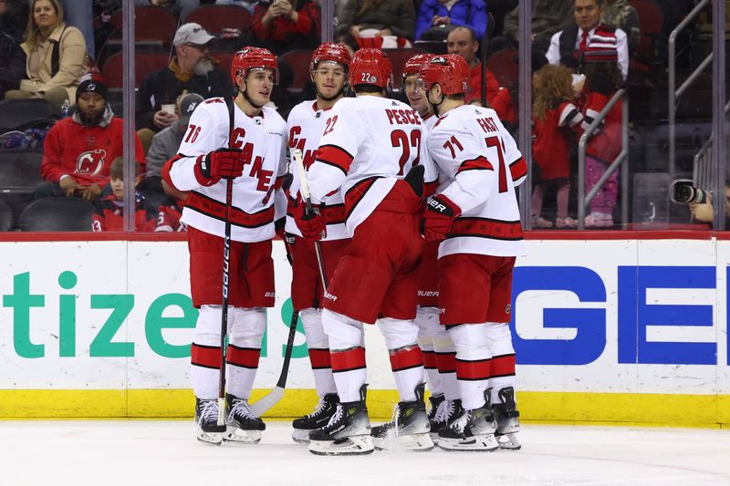 Mar 9, 2024; Newark, New Jersey, USA;Carolina Hurricanes center Jesperi Kotkaniemi (82) celebrates his goal against the New Jersey Devils during the third period at Prudential Center. Mandatory Credit: Ed Mulholland-USA TODAY Sports