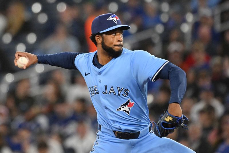 Apr 20, 2025; Toronto, Ontario, CAN;  Toronto Blue Jays relief pitcher Dillon Tate (9) delivers a pitch against the Seattle Mariners in the seventh inning at Rogers Centre. Mandatory Credit: Dan Hamilton-Imagn Images