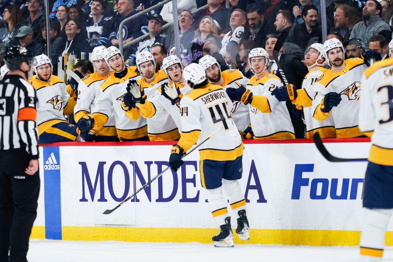 Mar 13, 2024; Winnipeg, Manitoba, CAN; Nashville Predators forward Keifer Sherwood (44) is congratulated by his team mates on his goal against the Winnipeg Jets during the first period at Canada Life Centre. Mandatory Credit: Terrence Lee-USA TODAY Sports