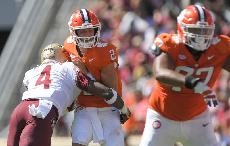 Sep 23, 2023; Clemson, South Carolina, USA; Florida State Seminoles linebacker Karen DeLoach (4) hits Clemson Tigers quarterback Cade Klubnik (2) To knock the ball loose before picking up the fumble and returning it for a touchdown during the third quarter at Memorial Stadium. Mandatory Credit: Ken Ruinard-USA TODAY Sports